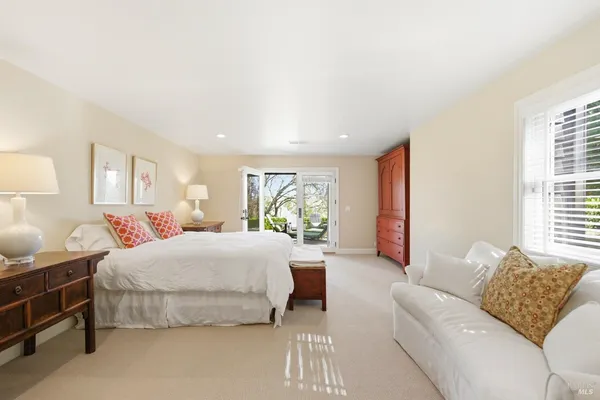 a bedroom with a bed couch and window