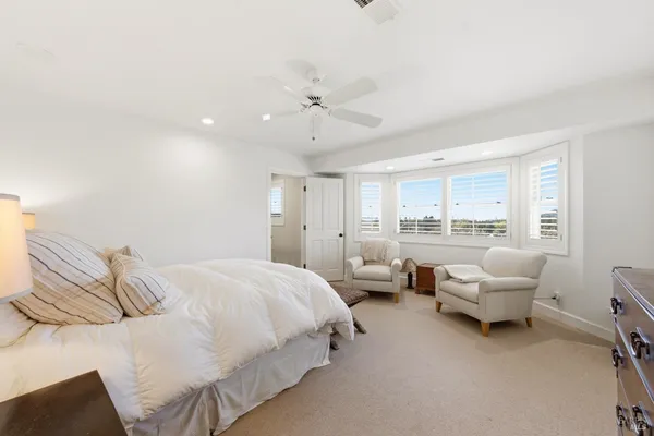 a bedroom with a bed couch and window