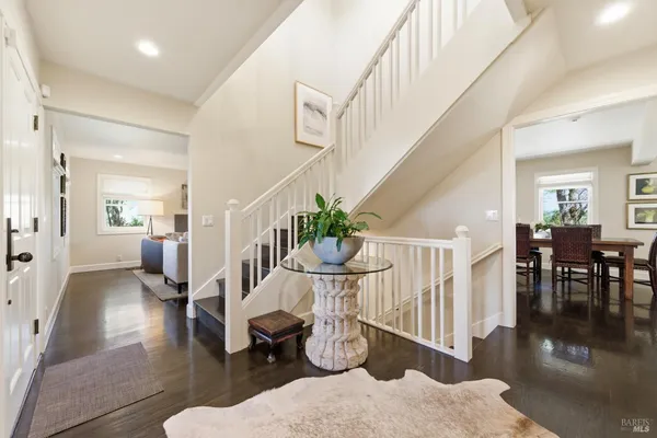 a view of entryway and hall with wooden floor