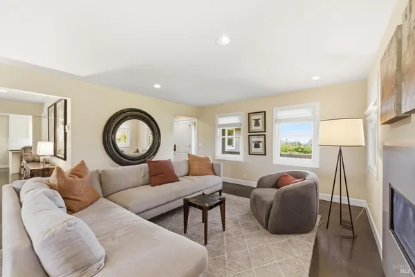 a living room with furniture a window and a lamp