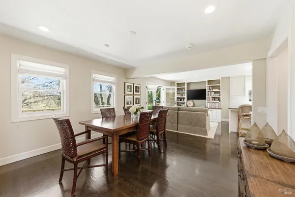 a dining room with furniture and wooden floor