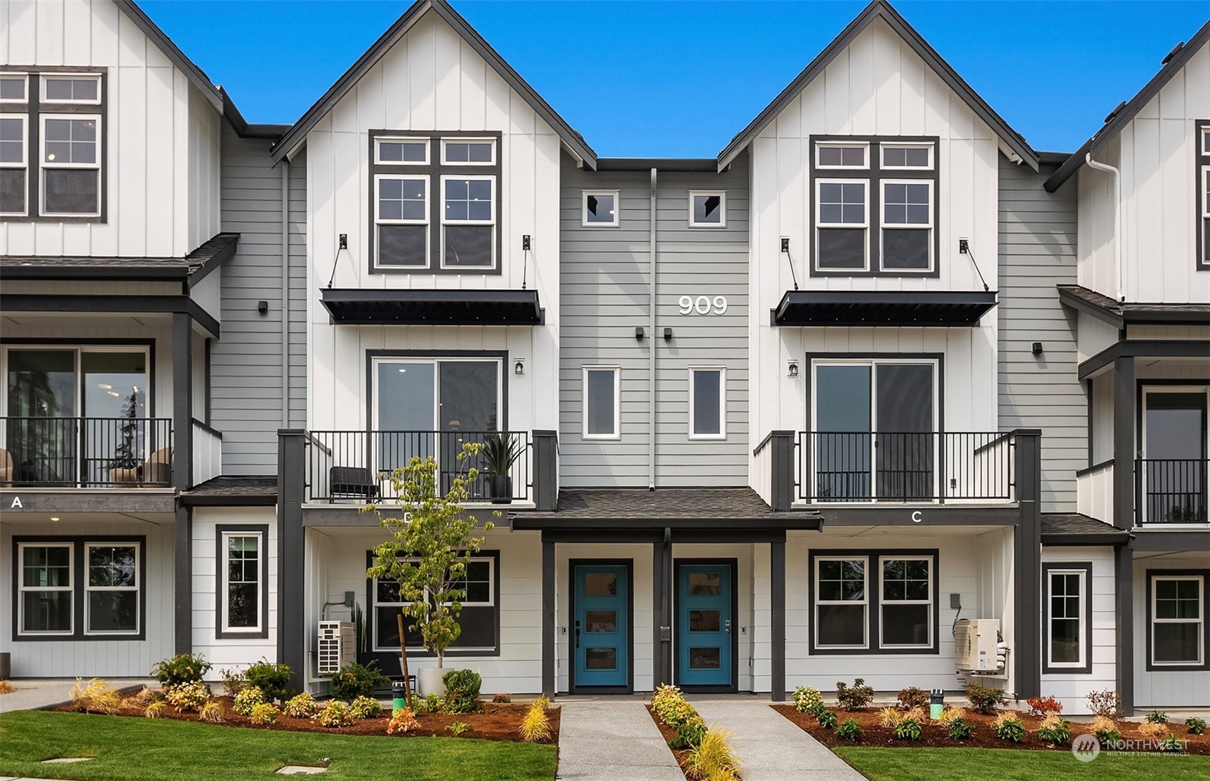 20348 91st Avenue Northeast, Unit C Bothell, WA 98021 - Photo 1 of 16 a front view of a residential apartment building with glass windows and yard