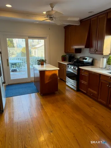 a kitchen with stainless steel appliances granite countertop a refrigerator and a sink