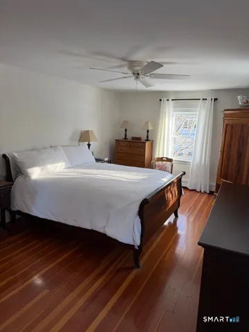 a bedroom with a bed and window