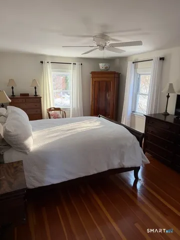 a bedroom with furniture and a wooden floor