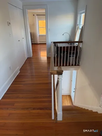 a view of balcony with furniture and wooden floor