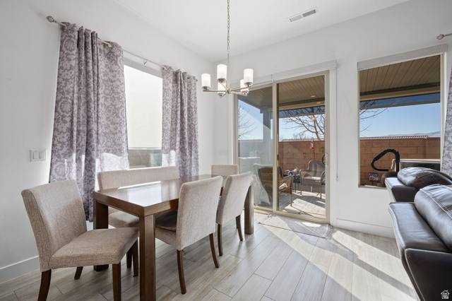 4708 Martin Drive St. George, UT 84790 - Photo 13 of 28 Dining area with a chandelier and light wood finished floors