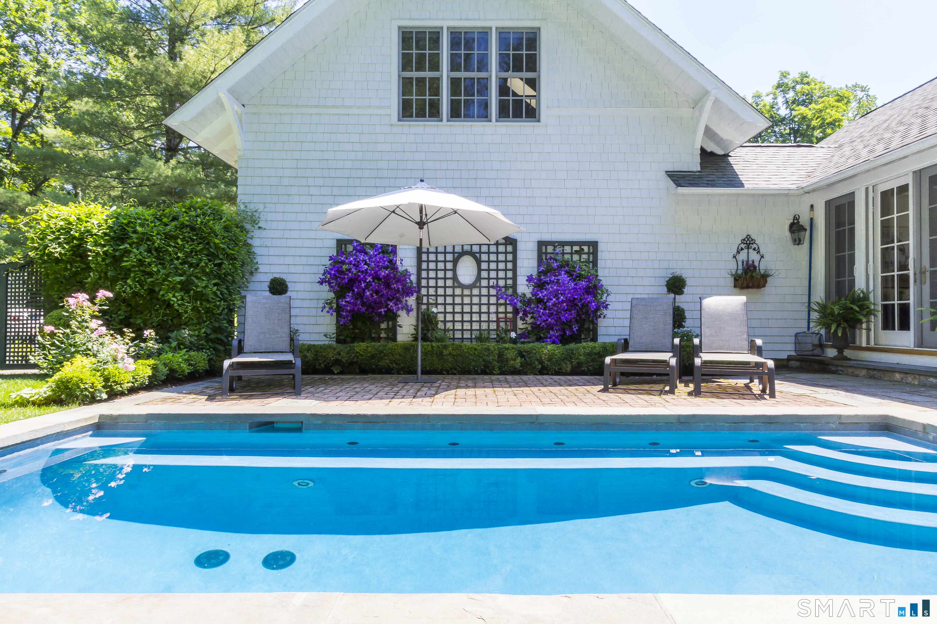 41 Peaceable Street Ridgefield, CT 06877 - Photo 36 of 40 a front view of house with yard and seating area