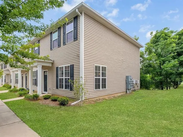 a view of a house with a backyard