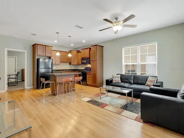 a living room with furniture and kitchen view