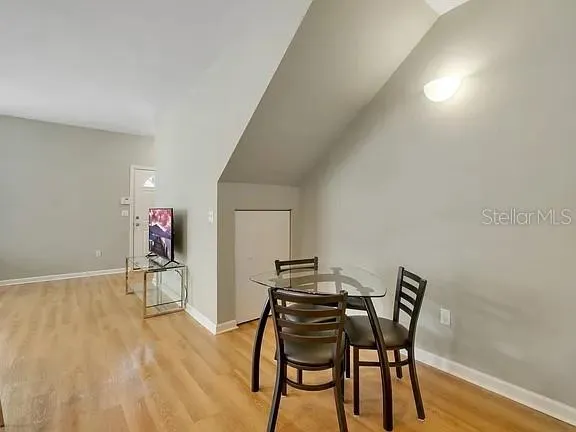 a view of a dining room with furniture and wooden floor