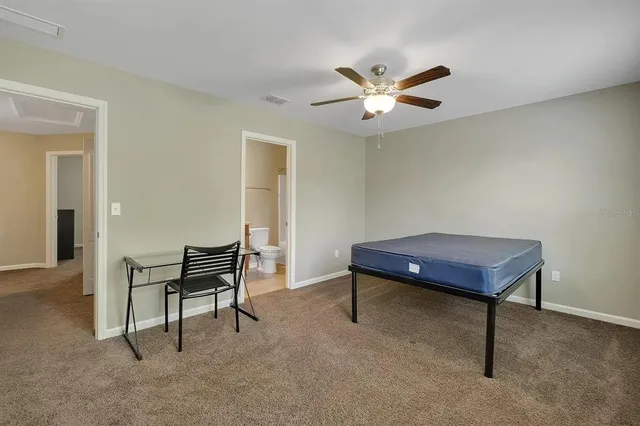 a room with furniture and a ceiling fan