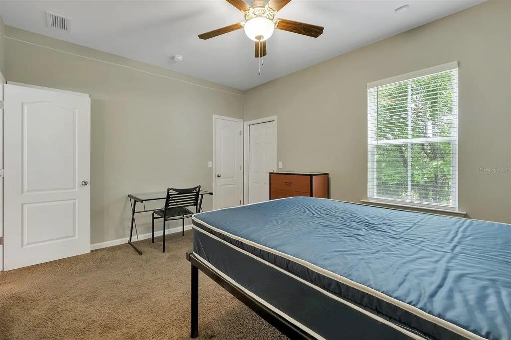 3660 Tyson Road, Unit 707 Tallahassee, FL 32310 - Photo 10 of 14 a bed sitting in a spacious bedroom next to a window