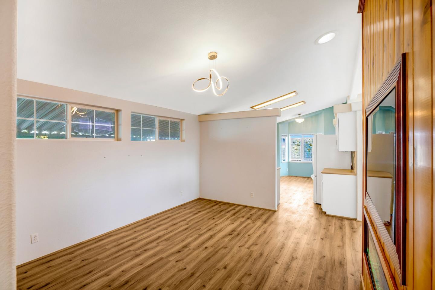 700 Briggs Street, Unit 84 Pacific Grove, CA 93950 - Photo 11 of 34 a view of empty room with wooden floor and fan
