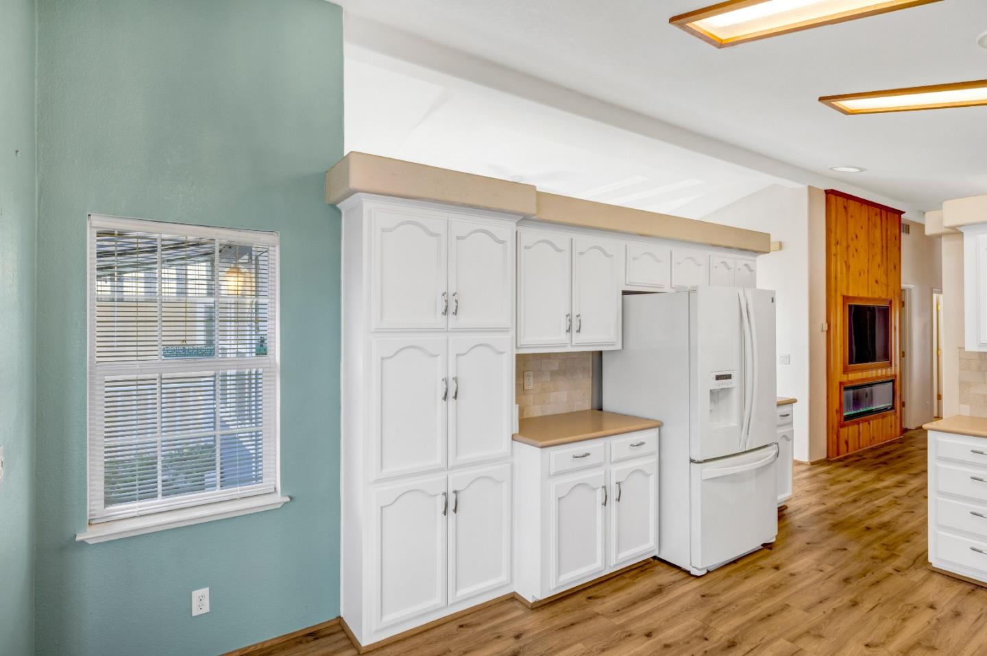 700 Briggs Street, Unit 84 Pacific Grove, CA 93950 - Photo 15 of 34 a view of a kitchen with wooden floor and electronic appliances