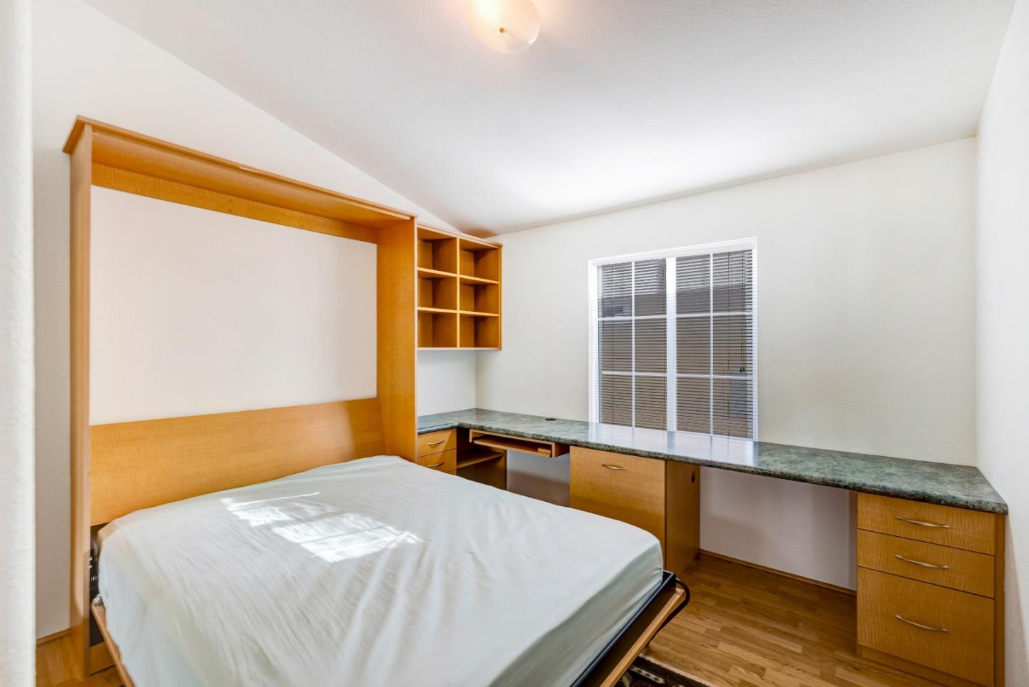 700 Briggs Street, Unit 84 Pacific Grove, CA 93950 - Photo 27 of 34 a bed sitting in a bedroom next to a window