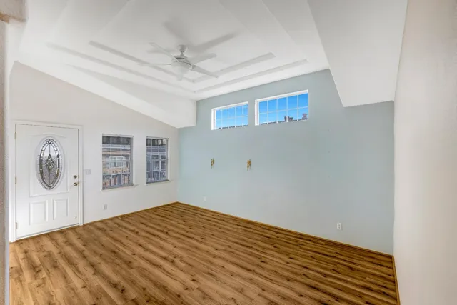 a view of empty room with wooden floor