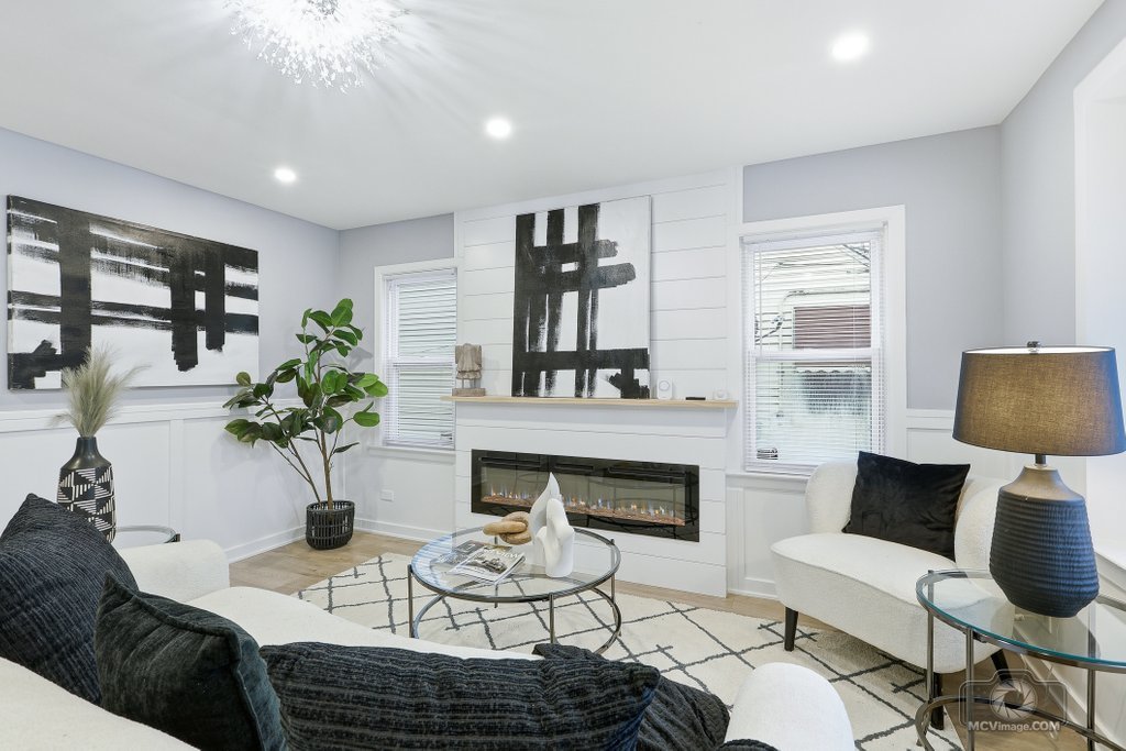 440 Engle Street Dolton, IL 60419 - Photo 4 of 19 a living room with furniture a fireplace and a chandelier