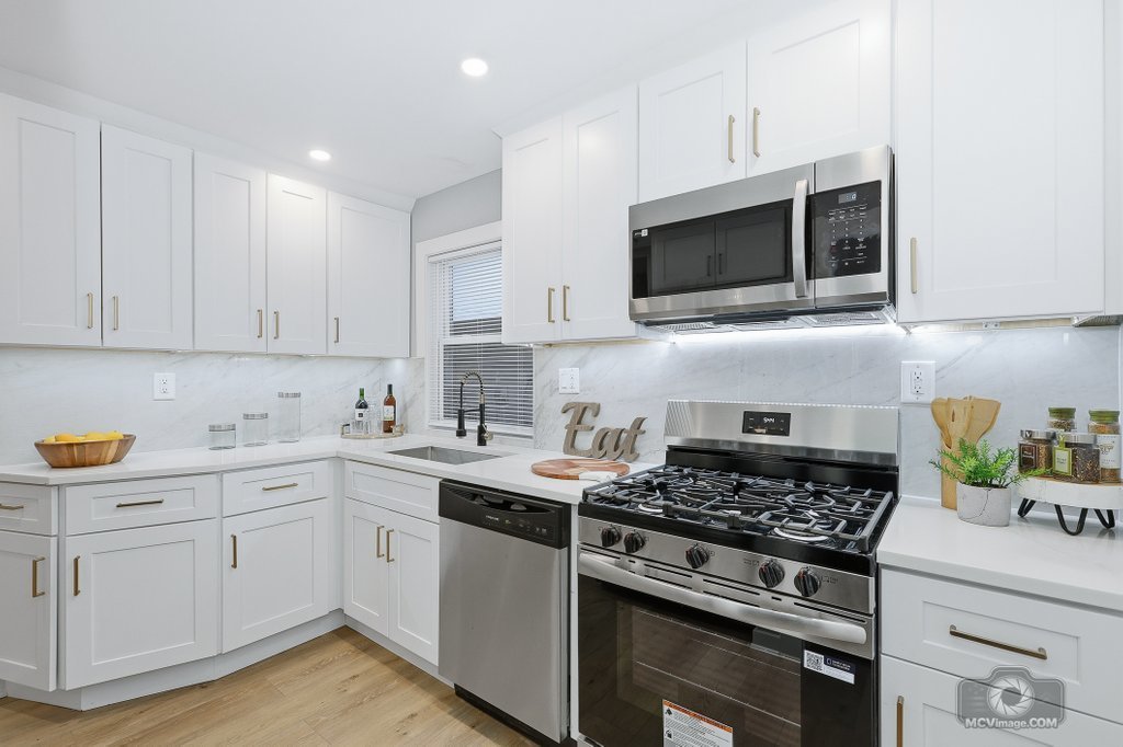 440 Engle Street Dolton, IL 60419 - Photo 7 of 19 a kitchen with stainless steel appliances granite countertop a stove a sink and a microwave