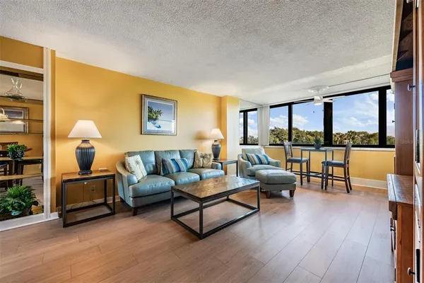 a living room with furniture and a wooden floor