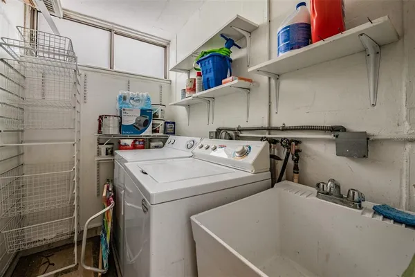 an aerial view of ocean and residential houses with outdoor space