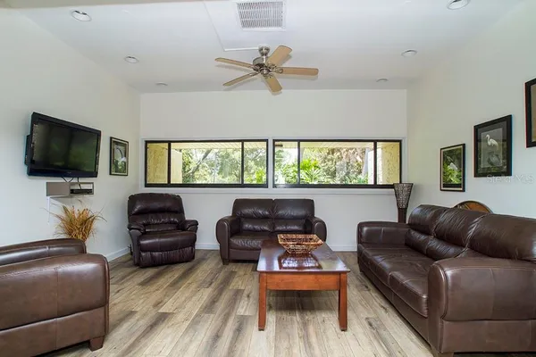 a view of a dining room and livingroom with furniture window and wooden floor