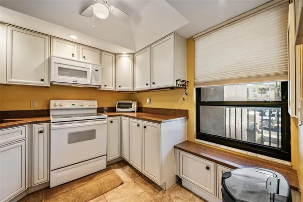 a kitchen with cabinets appliances and a sink