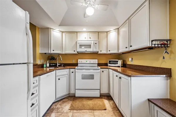 a kitchen with a refrigerator and a stove