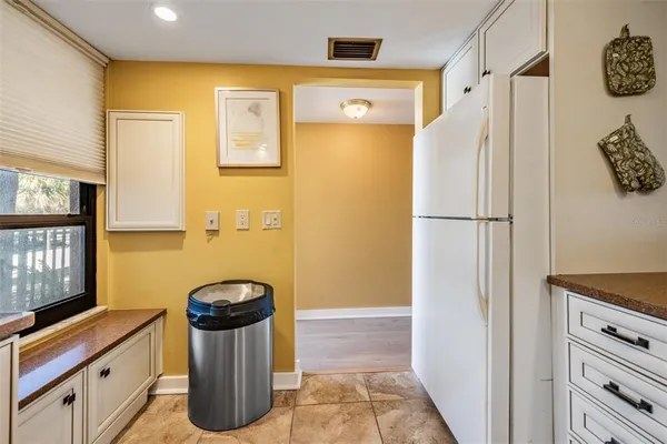 a kitchen with a sink cabinets and window