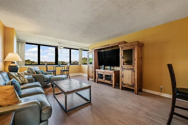 a living room with furniture and a floor to ceiling window