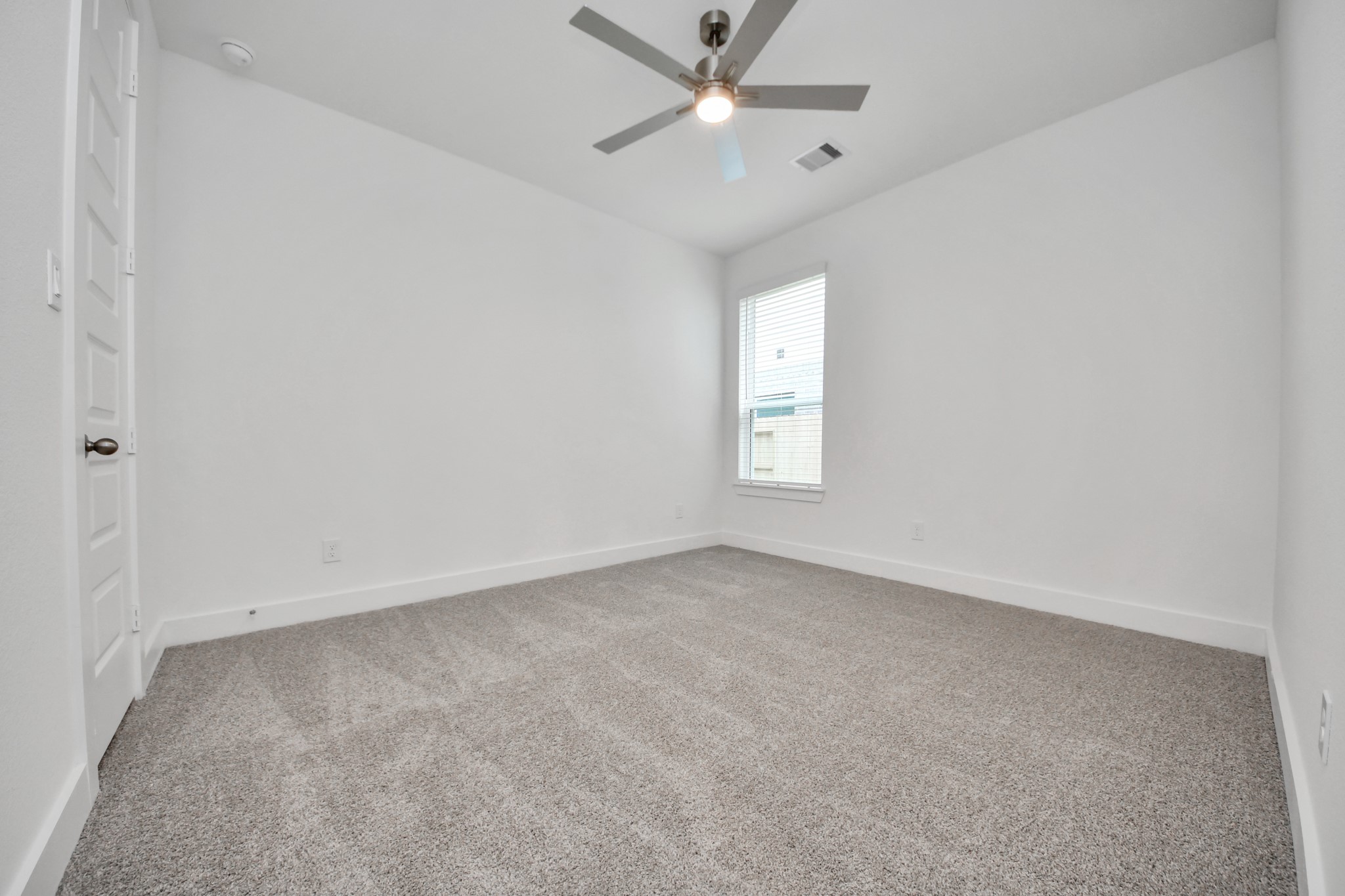 3046 Native Spg Drive Spring, TX 77373 - Photo 34 of 35 Secondary bedroom features plush carpeting, large windows that let in plenty of natural light, bright paint, and spacious closets. Sample photo of completed home with similar floor plan. Actual colors and selections may vary.