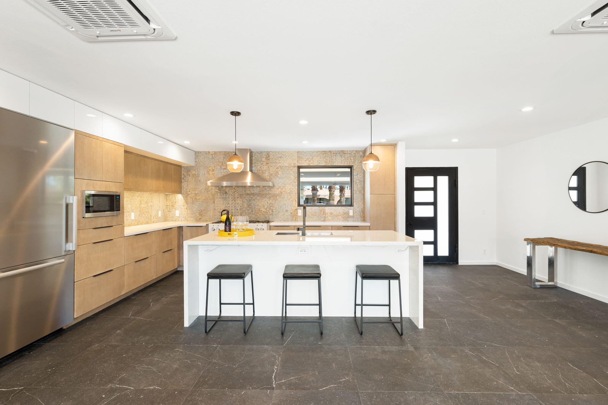 70131 Chappel Road Rancho Mirage, CA 92270 - Photo 15 of 42 a kitchen with cabinets and chairs
