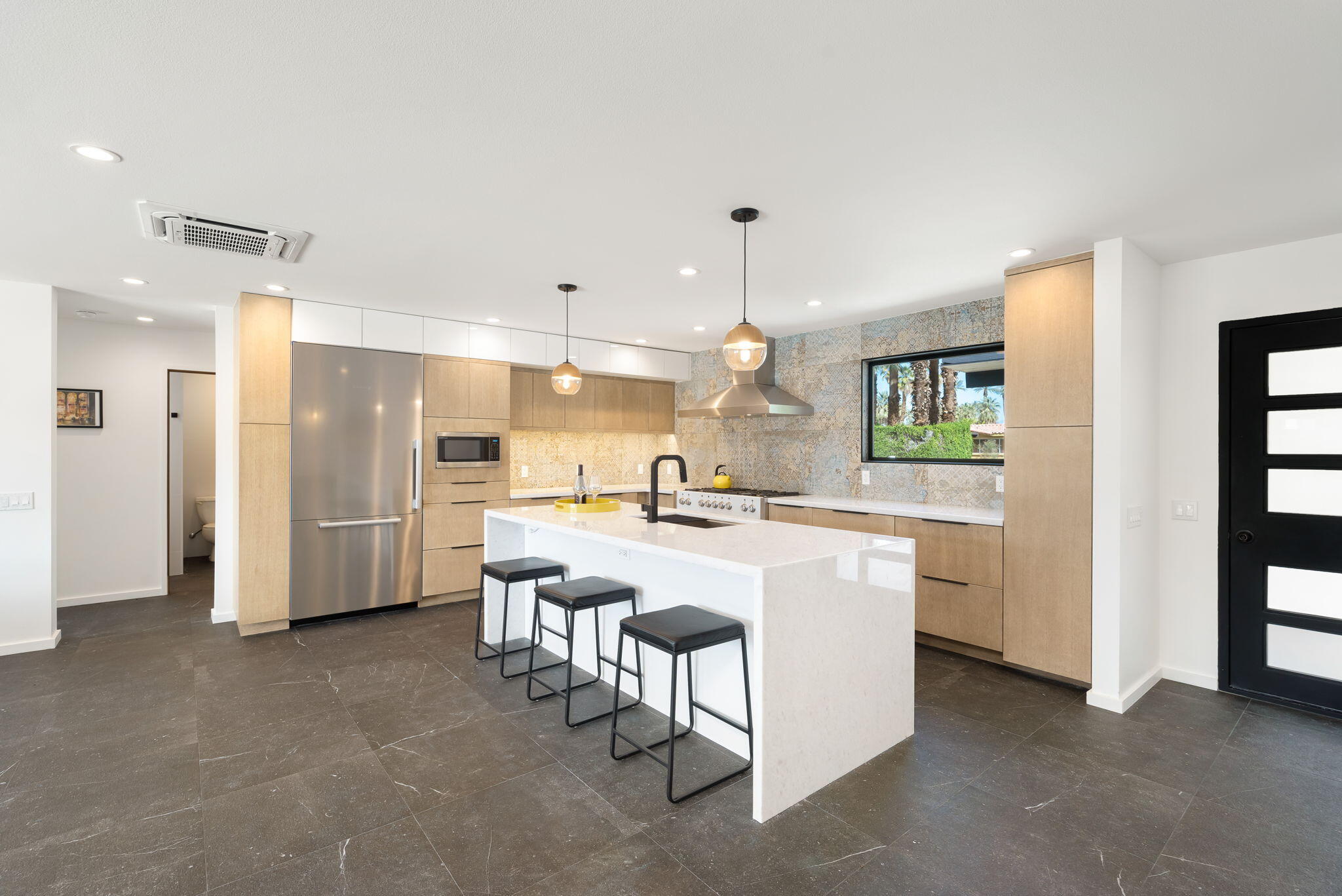 70131 Chappel Road Rancho Mirage, CA 92270 - Photo 16 of 42 a large white kitchen with a sink and a refrigerator