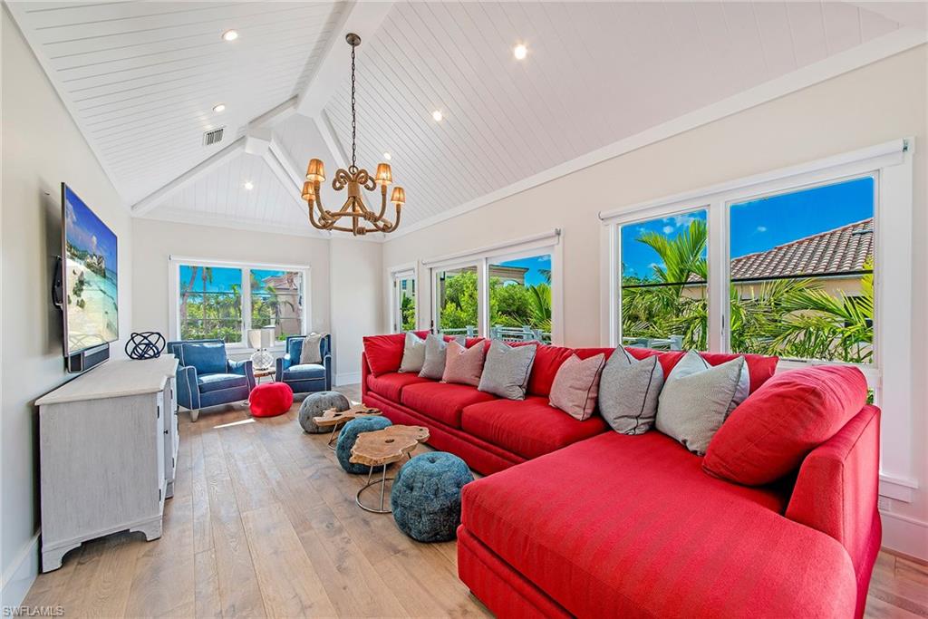 434 3rd Avenue South Naples, FL 34102 - Photo 14 of 24 a living room with furniture a window and a chandelier