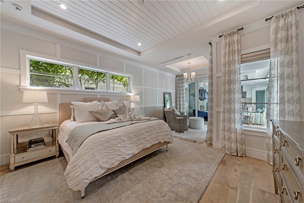 434 3rd Avenue South Naples, FL 34102 - Photo 17 of 24 a bedroom with a bed mirror and a window