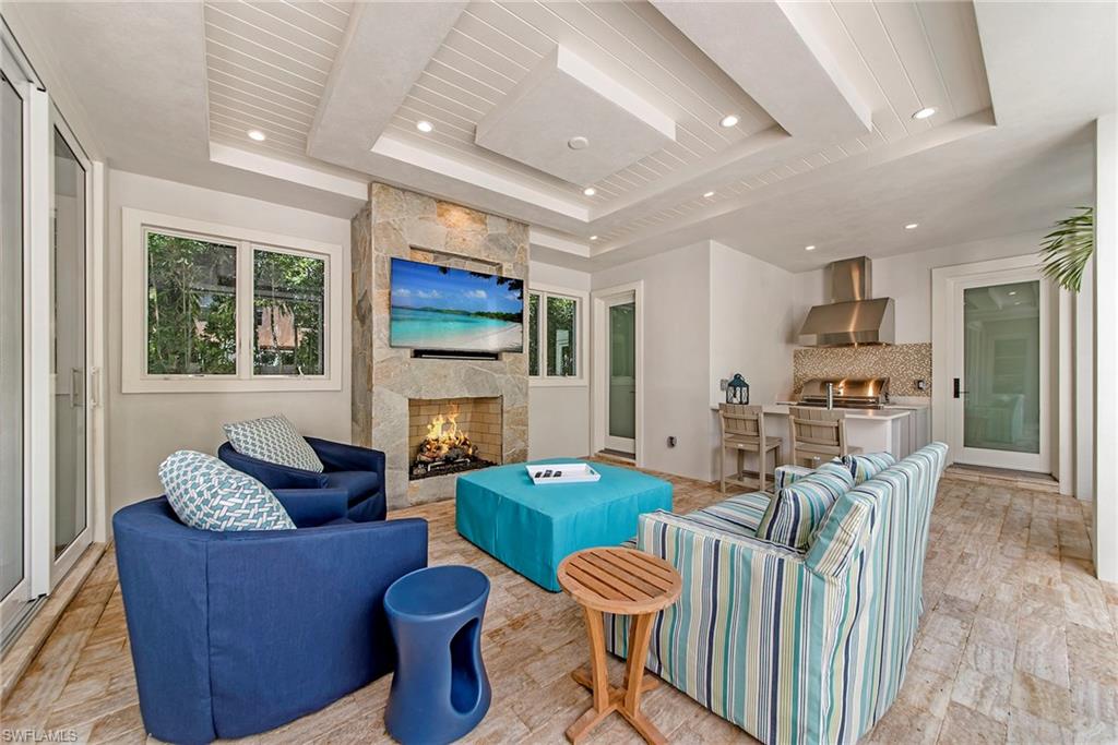 434 3rd Avenue South Naples, FL 34102 - Photo 19 of 24 a living room with fireplace furniture and a large window