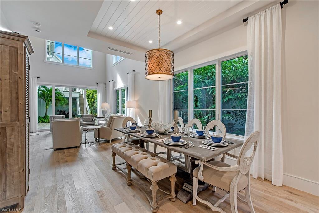 434 3rd Avenue South Naples, FL 34102 - Photo 4 of 24 a dining room with wooden floor table and chairs
