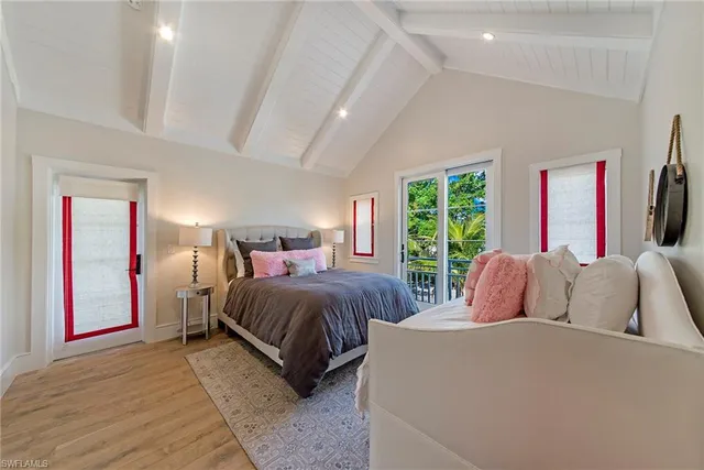 a bedroom with a large bed and a large window