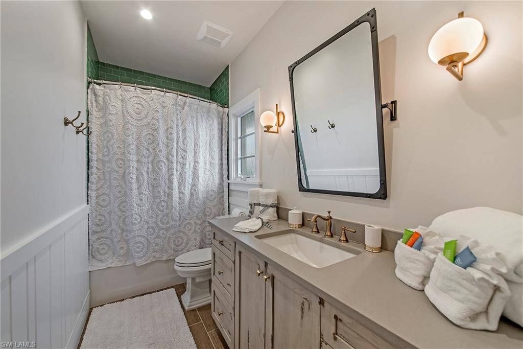434 3rd Avenue South Naples, FL 34102 - Photo 10 of 24 a bathroom with a granite countertop sink mirror and toilet