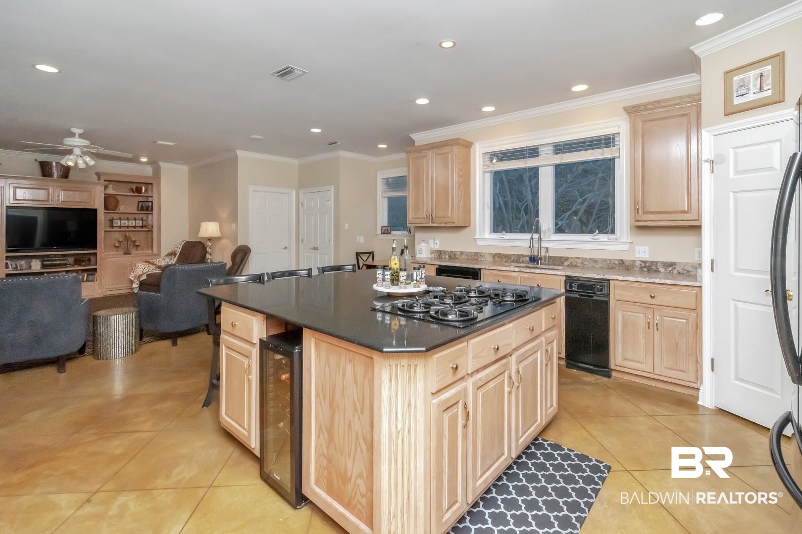 1050 Southern Way Court Mobile, AL 36609 - Photo 6 of 36 Kitchen with a kitchen island, light brown cabinetry, stainless steel gas stovetop, sink, and beverage cooler