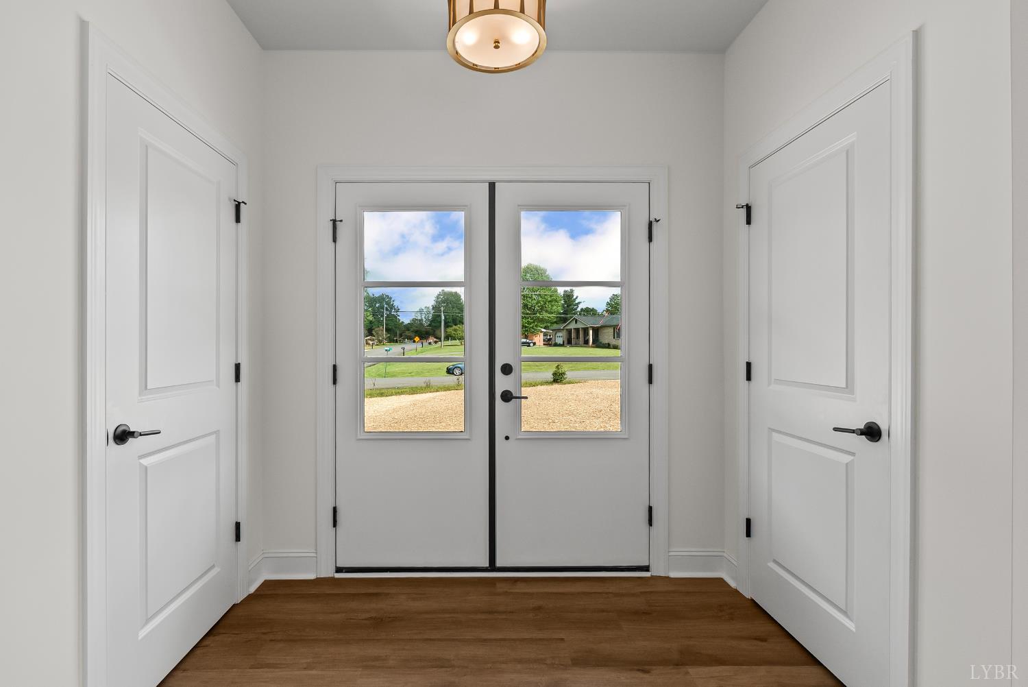 a view of empty room with wooden floor