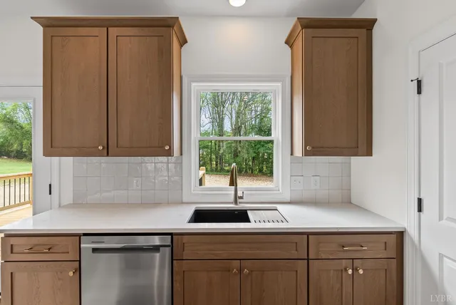 a kitchen with a sink cabinets and window