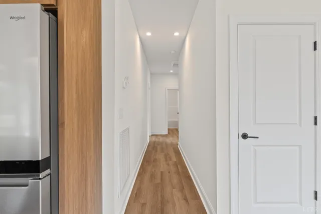 a view of a hallway with a wooden floor
