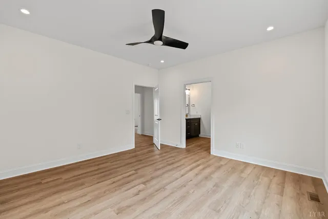 a view of an empty room and wooden floor