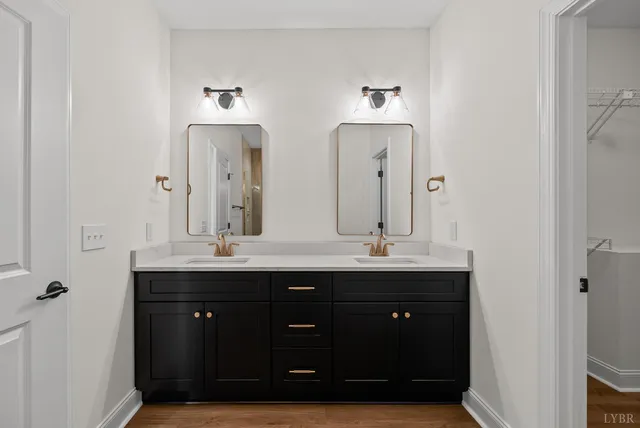 a bathroom with a double vanity sink and a mirror