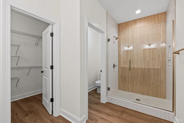 a bathroom with a shower and a glass door