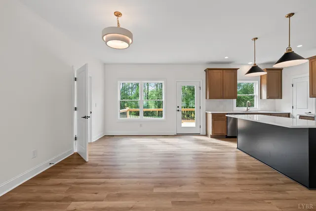 a view of a kitchen with a sink a fireplace and wooden floor