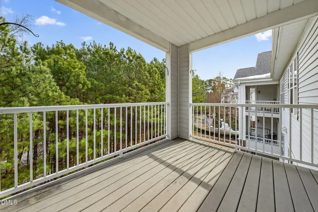a view of a balcony with wooden floor