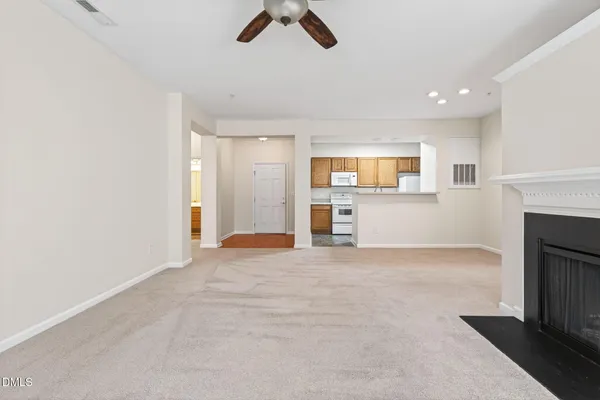 a view of an empty room with a fireplace