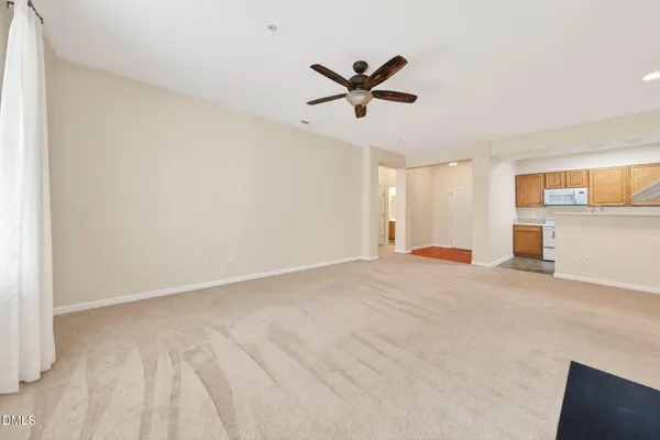 an empty room with fireplace and windows